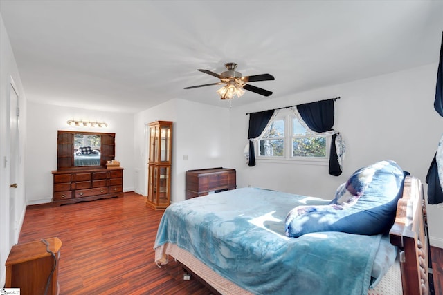 bedroom with dark wood-type flooring and ceiling fan