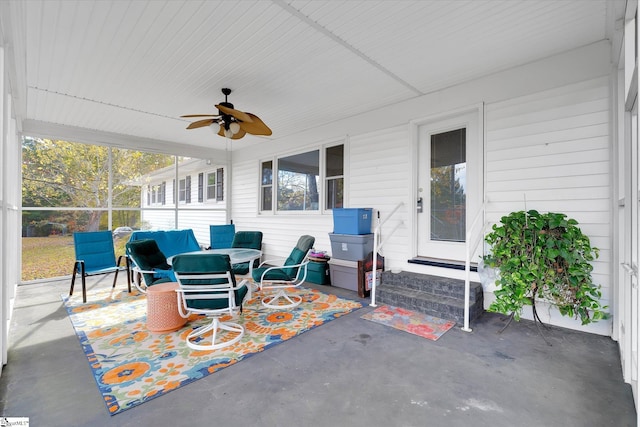 sunroom / solarium featuring ceiling fan