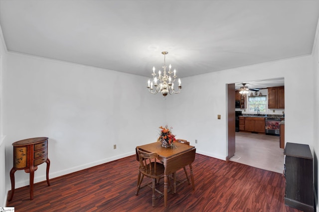 dining area featuring dark hardwood / wood-style floors, sink, ceiling fan with notable chandelier, and ornamental molding