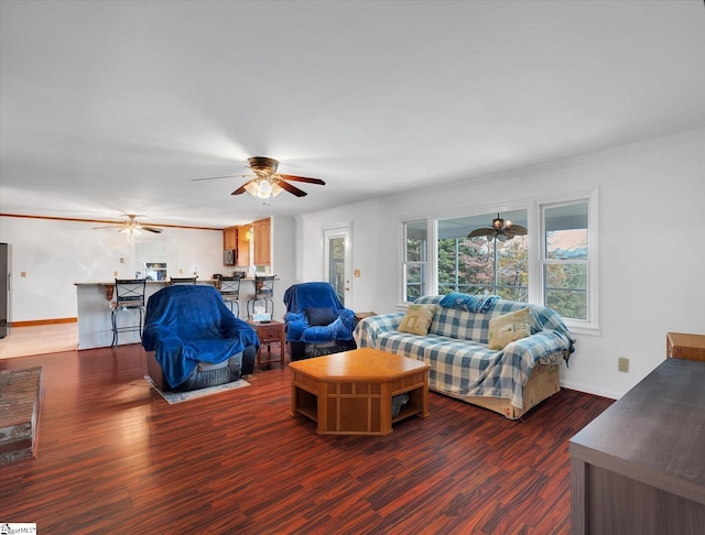 living room with dark hardwood / wood-style flooring and crown molding