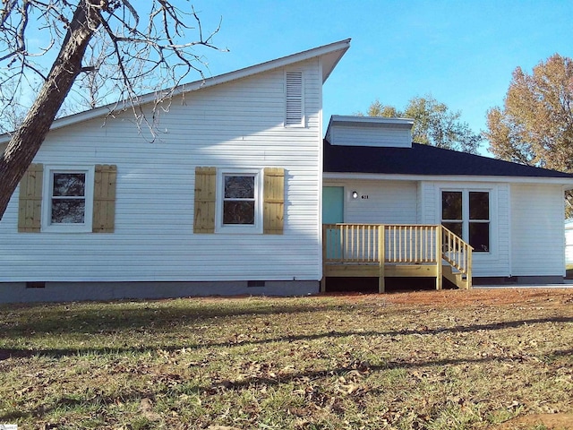 back of property featuring a lawn