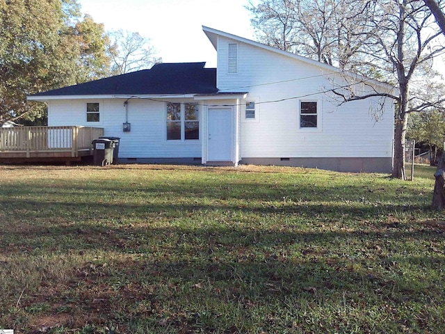 back of house with a wooden deck and a yard