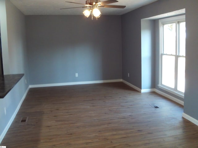 spare room featuring ceiling fan and dark hardwood / wood-style flooring