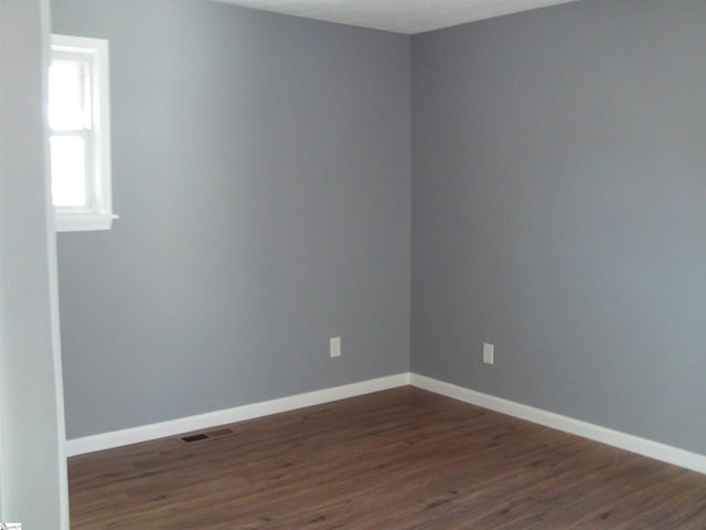 empty room featuring dark hardwood / wood-style floors