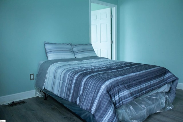 bedroom featuring dark wood-type flooring