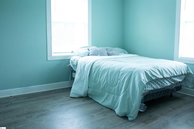 bedroom featuring hardwood / wood-style floors and multiple windows