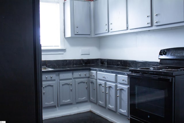 kitchen featuring gray cabinetry and electric range