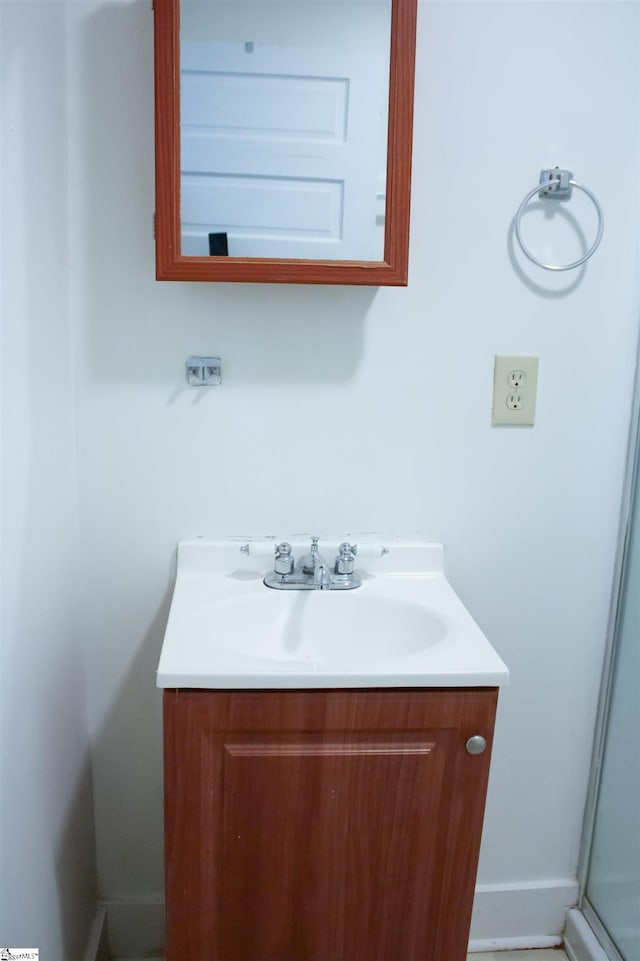 bathroom featuring an enclosed shower and vanity