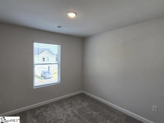 empty room with a wealth of natural light and carpet floors