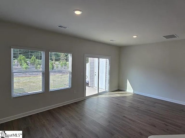 spare room featuring dark hardwood / wood-style flooring