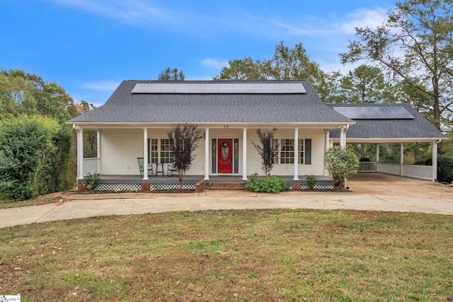 view of front facade with a porch, solar panels, and a front yard