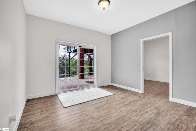 unfurnished room with light wood-type flooring