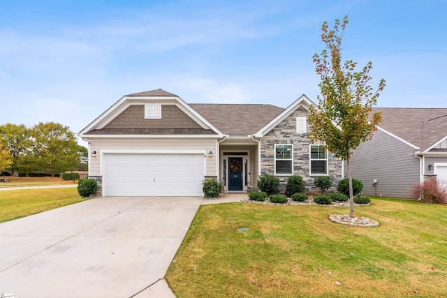 view of front of home featuring a front yard and a garage