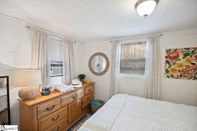 bedroom featuring multiple windows and cooling unit