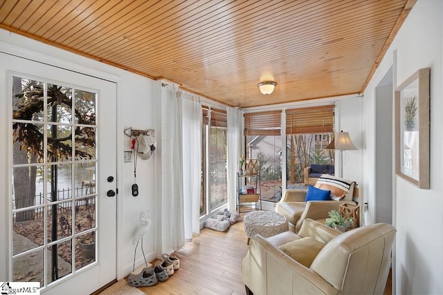 sunroom featuring a healthy amount of sunlight and wood ceiling