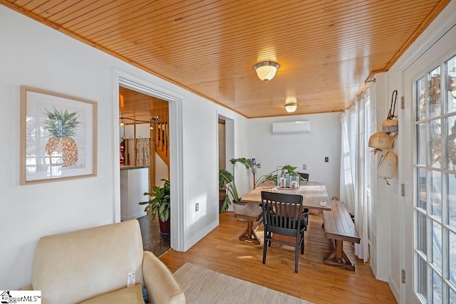 dining area featuring a wall unit AC, wooden ceiling, ornamental molding, and light hardwood / wood-style flooring