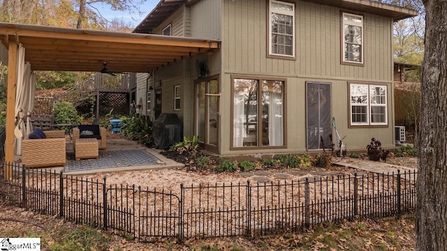 back of property featuring a patio area and ceiling fan