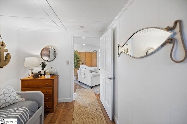 corridor featuring hardwood / wood-style flooring and crown molding