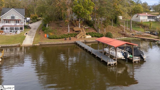 dock area with a water view and a lawn