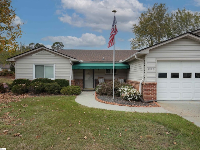 ranch-style house with a garage and a front lawn