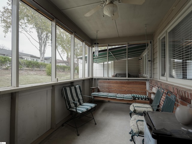 sunroom / solarium featuring ceiling fan