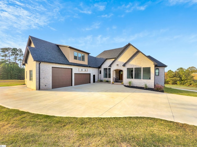 view of front of house with a front yard and a garage