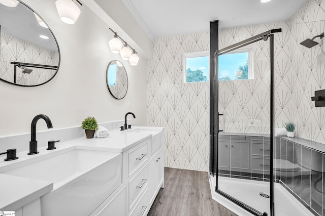 bathroom with vanity, an enclosed shower, and wood-type flooring