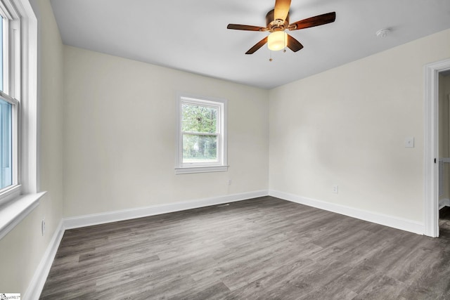 unfurnished room with dark hardwood / wood-style floors and ceiling fan