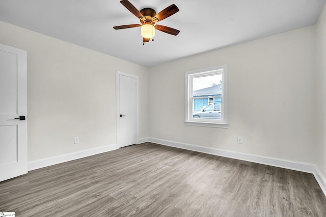 spare room with wood-type flooring and ceiling fan