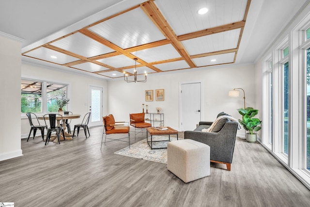 living room featuring coffered ceiling, hardwood / wood-style floors, beam ceiling, and a notable chandelier