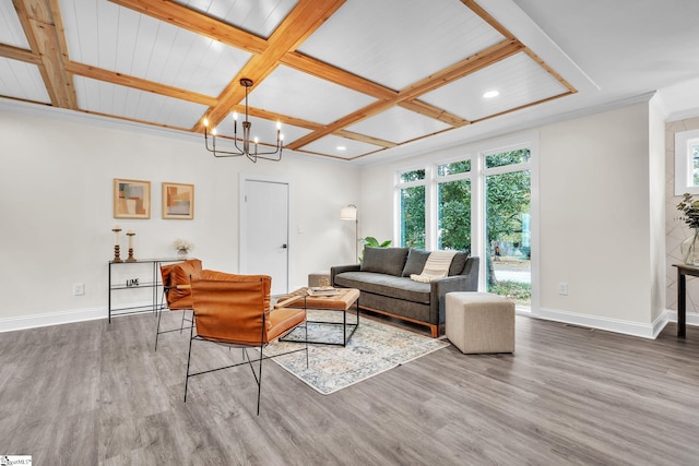 living room featuring hardwood / wood-style flooring, crown molding, coffered ceiling, a notable chandelier, and beamed ceiling