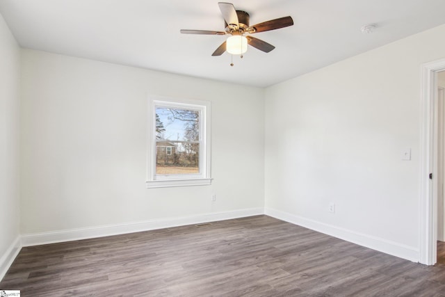 unfurnished room with dark hardwood / wood-style flooring and ceiling fan