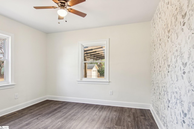 unfurnished room with dark hardwood / wood-style flooring and ceiling fan