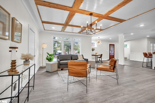 living room featuring coffered ceiling, beam ceiling, and a notable chandelier