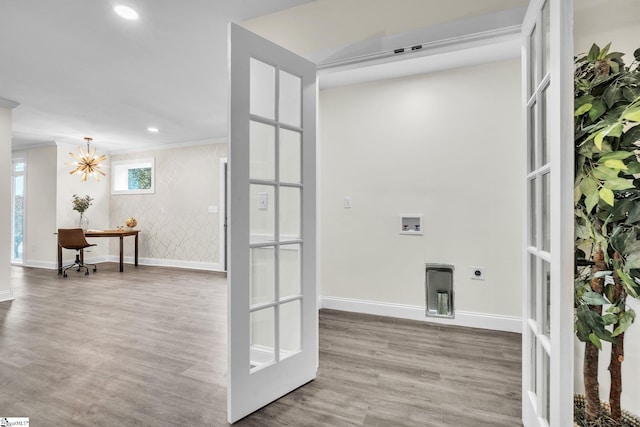 washroom featuring electric dryer hookup, hookup for a washing machine, french doors, and hardwood / wood-style flooring