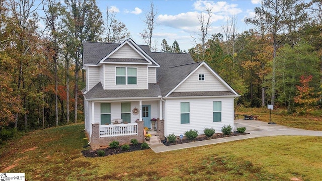 craftsman house with covered porch and a front yard