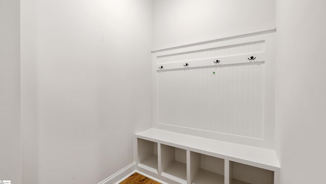 mudroom featuring baseboards and wood finished floors
