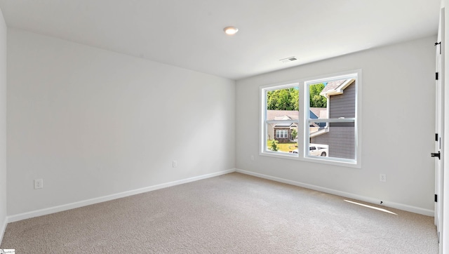 unfurnished room with baseboards and carpet flooring