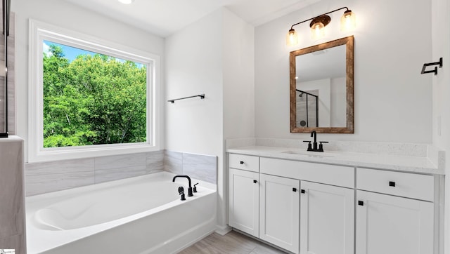 full bathroom with a bath, vanity, and a stall shower