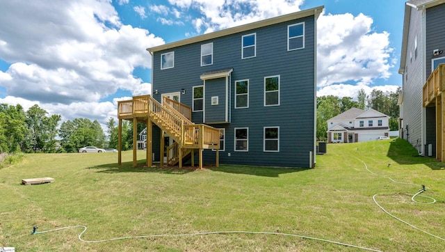 rear view of house featuring stairway, a deck, cooling unit, and a lawn