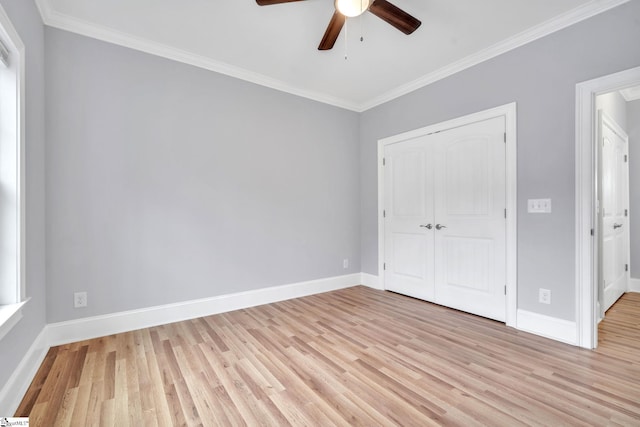 unfurnished bedroom with ceiling fan, a closet, light wood-type flooring, and ornamental molding