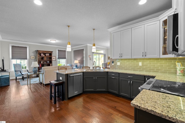 kitchen with a kitchen bar, stainless steel appliances, dark hardwood / wood-style flooring, white cabinets, and sink