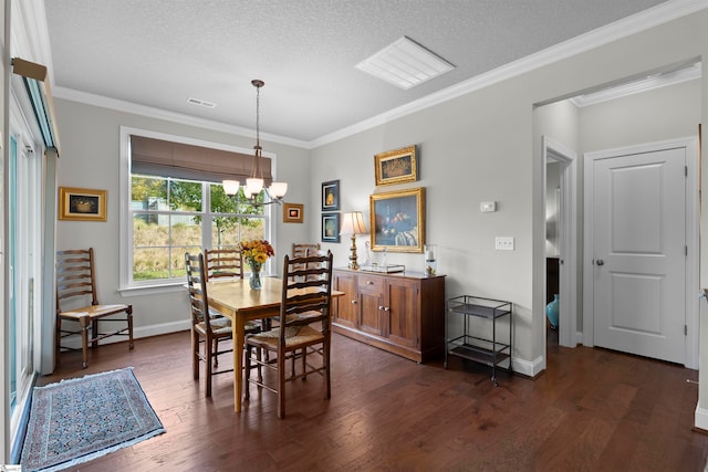 dining space with a chandelier, dark wood-type flooring, a textured ceiling, and crown molding