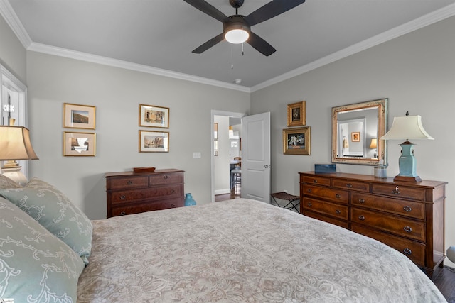 bedroom with hardwood / wood-style floors, ceiling fan, and crown molding