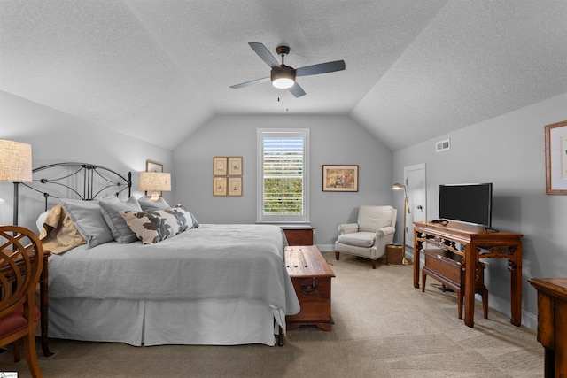 carpeted bedroom with a textured ceiling, lofted ceiling, and ceiling fan