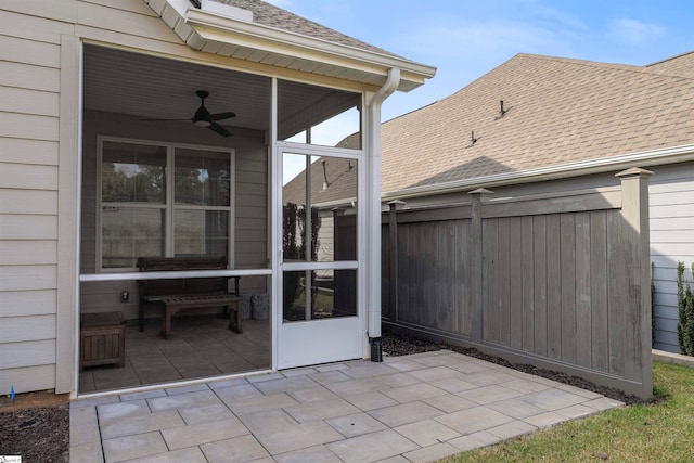 view of patio with ceiling fan and a sunroom