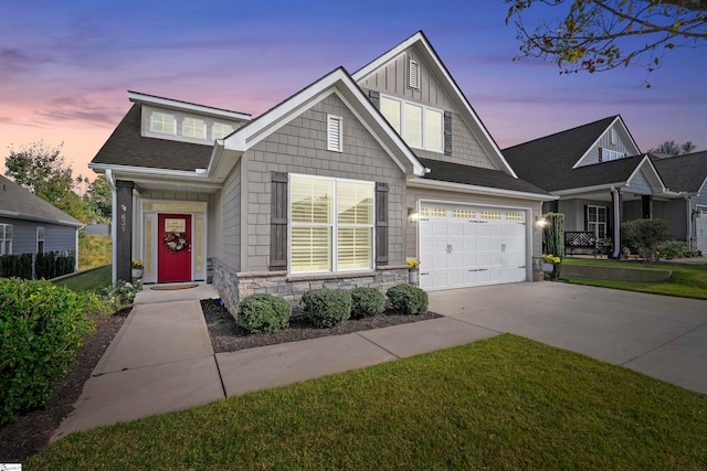 view of front facade with a garage and a lawn