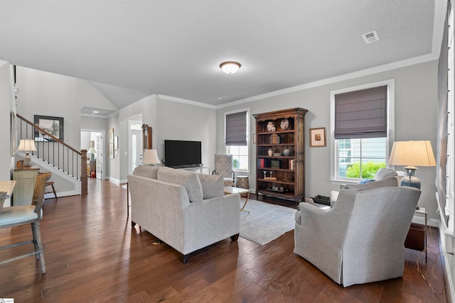 living room featuring ornamental molding, a wealth of natural light, and dark wood-type flooring