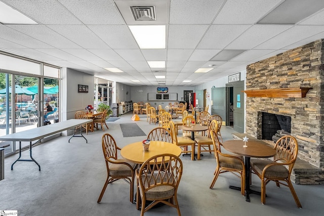425 Tiger Ln, Westminster, SC 29693 - dining room with finished concrete flooring, a stone fireplace, and a drop ceiling