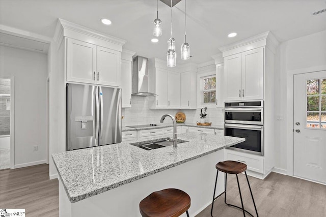 425 Tiger Ln, Westminster, SC 29693 - kitchen with stainless steel appliances, wall chimney range hood, a sink, light wood-style flooring, and recessed lighting